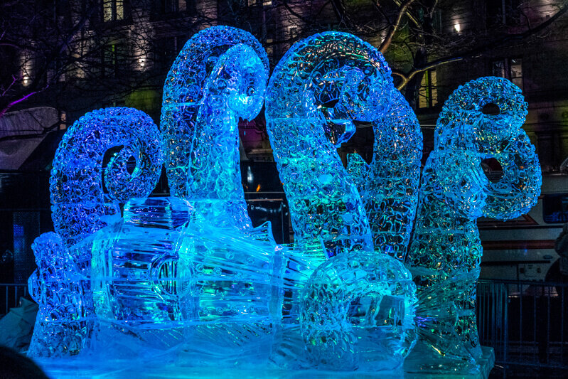An ice sculpture of octopus tentacles holding a glass or container.