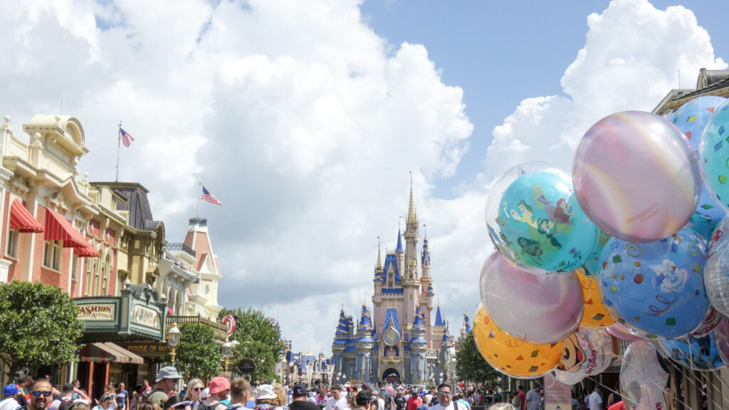 image of pink and blue castle with colorful balloons