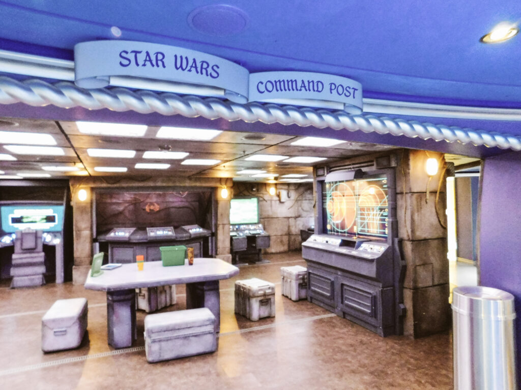 A large room with a table, chairs, and various Star Wars-themed workstations with a sign which reads "Star Wars Command Post."